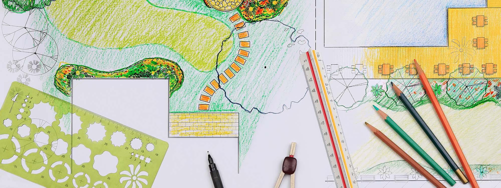 Colored landscape design drawing with pencils, ruler, and template on paper